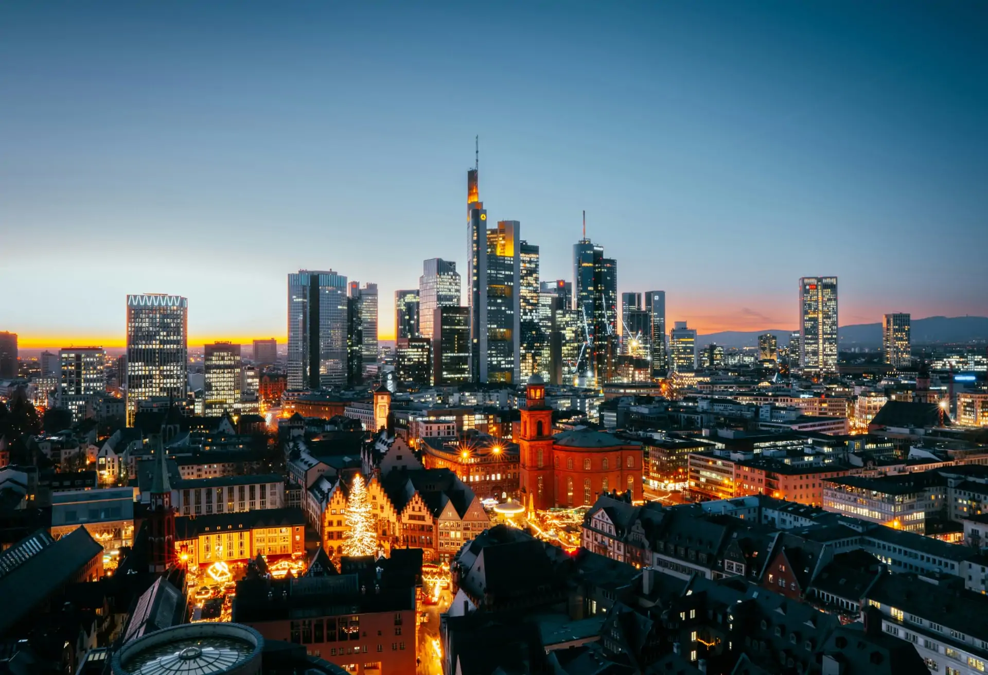 A mix of old and new in Frankfurt, with modern skyscrapers in the background and more historical buildings in front.