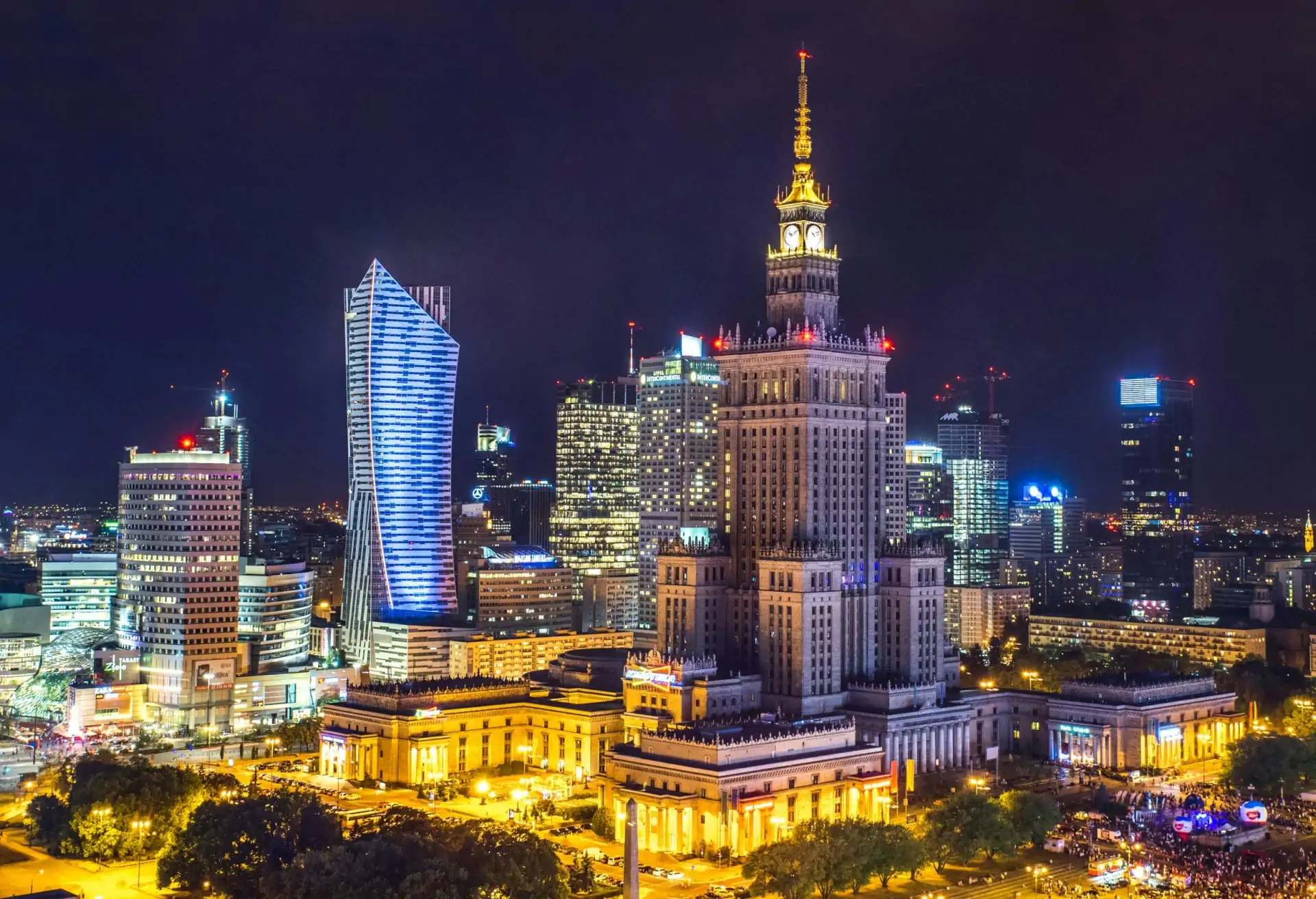 A view of skyscrapers and modern and older buildings in Warsaw, including the Palace of Culture and Science.