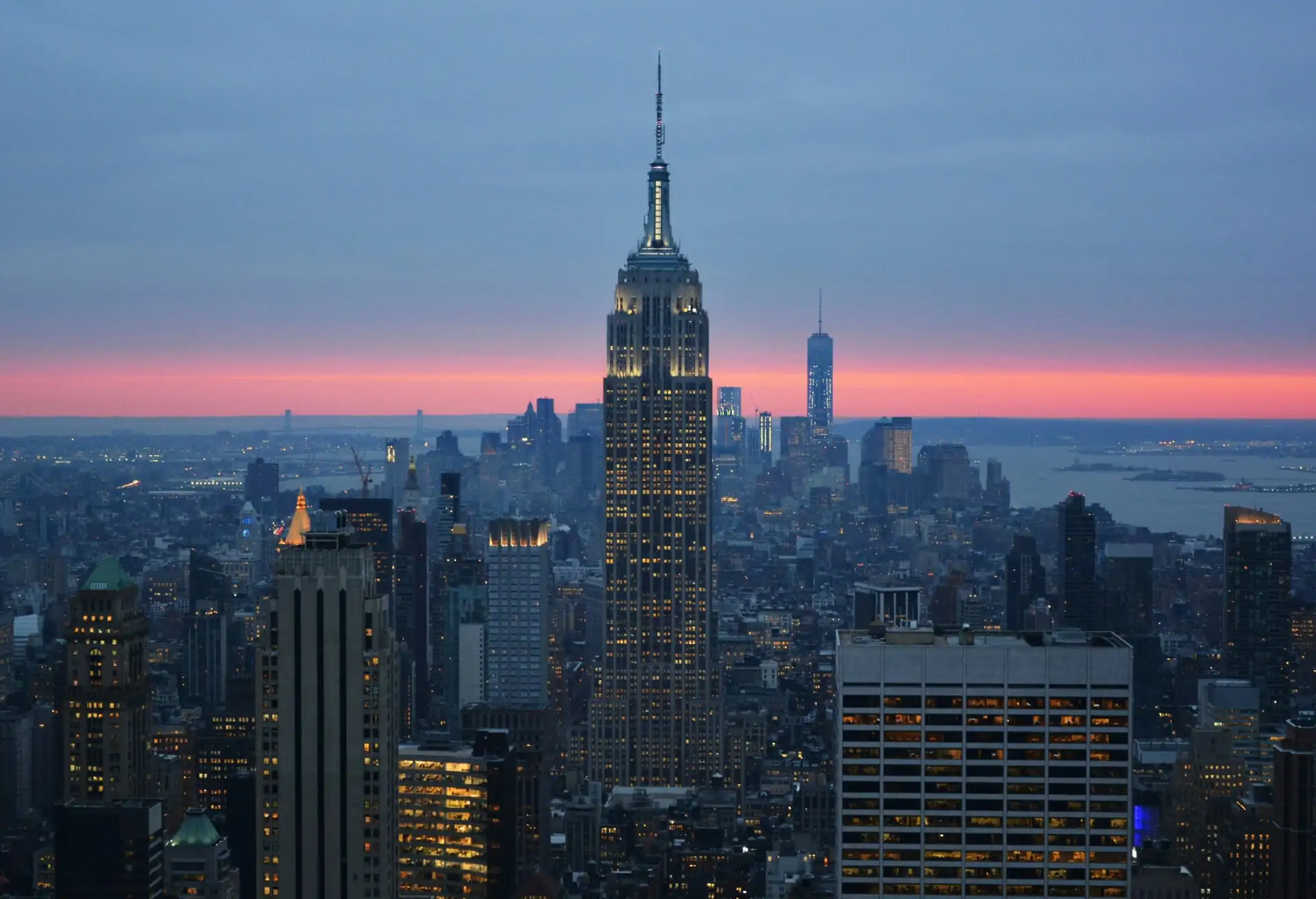 A view of New York City’s skyline at sunset with the Empire State Building as the central point.