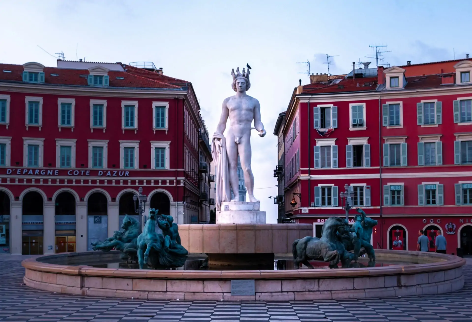 The Fontaine du Soleil which features a tall sculpture of a Greek god figure wearing a crown.