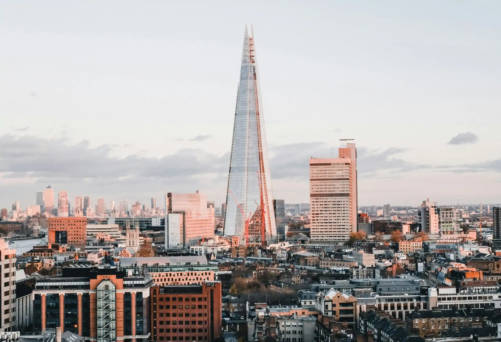 A view of The Shard in London with other modern buildings below.