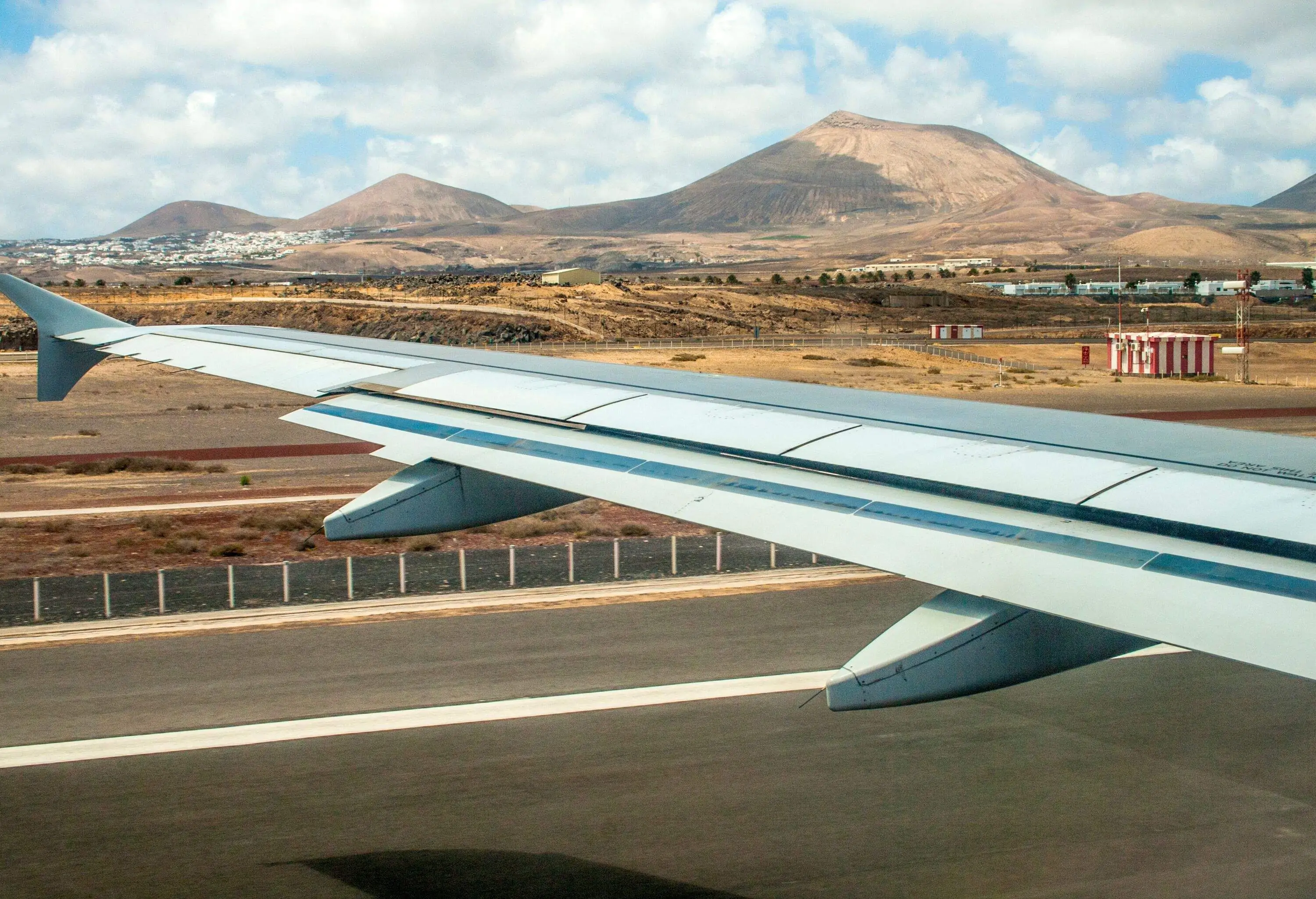 takeoff at airport of Lanzarote with volcanoes at the horizon