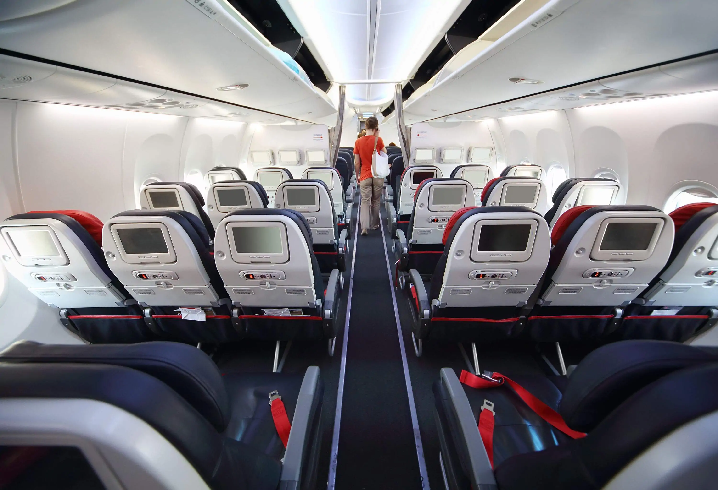 The last of the passengers going down the aisle to exit the aircraft as it touched down.