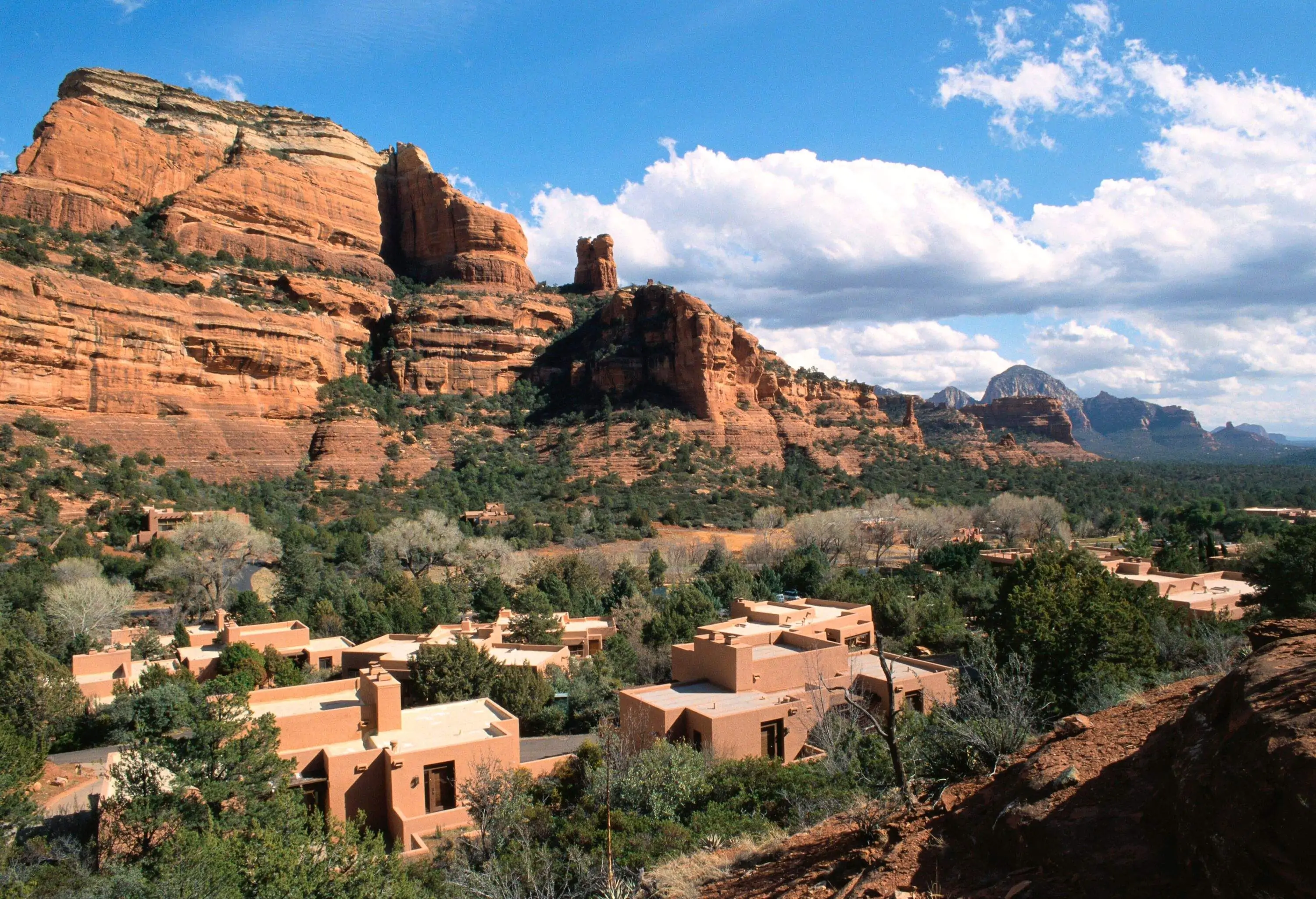 High angle view of red canyon with single houses camouflaging with the landscape on a sunny day